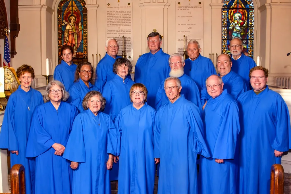 The St. John's choir in blue robes before the altar, June 2026