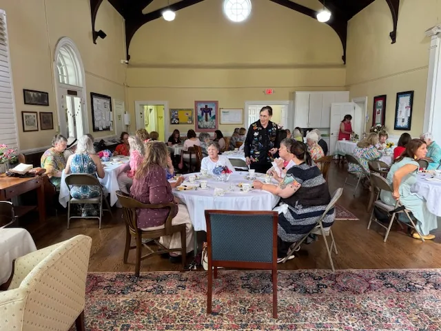 Guests at round tables during the Ladies Tea in the parish hall