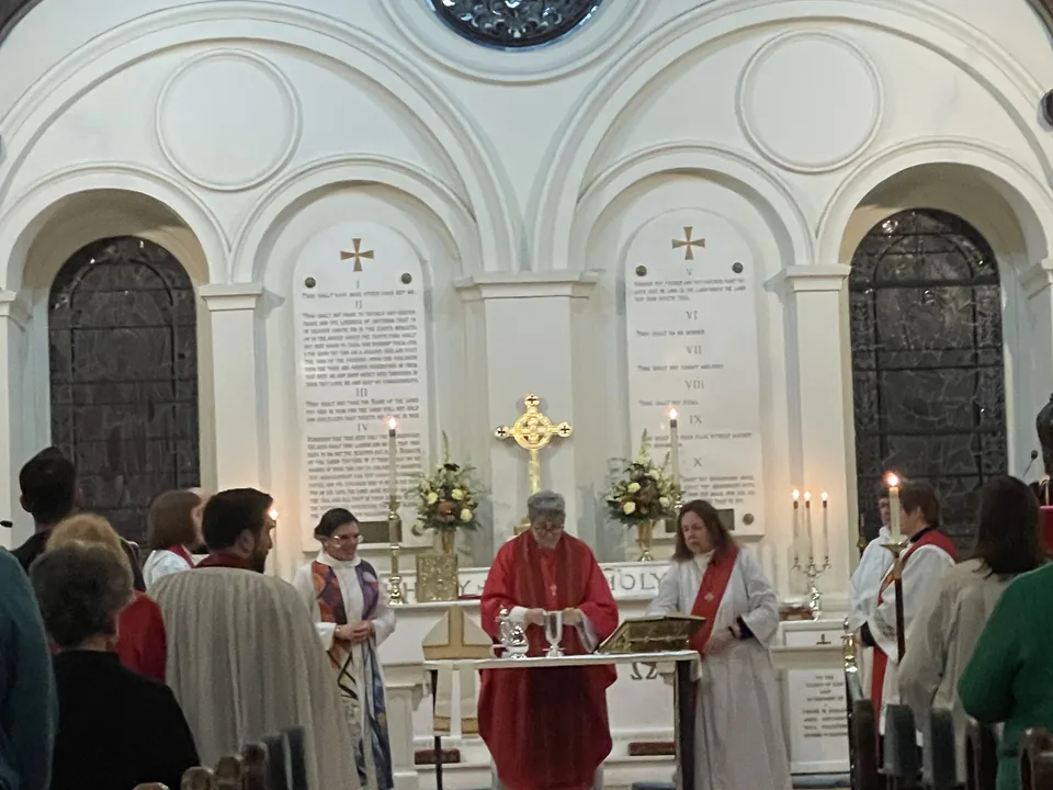 The bishop celebrating the Holy Eucharist at the altar of St. John's, flanked by clergy