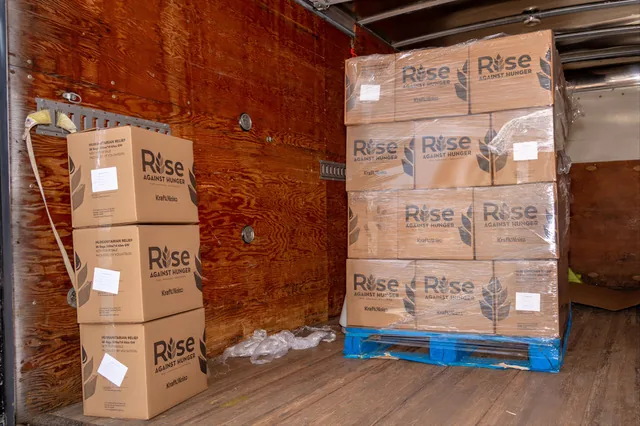 Rise Against Hunger meal boxes stacked in a truck