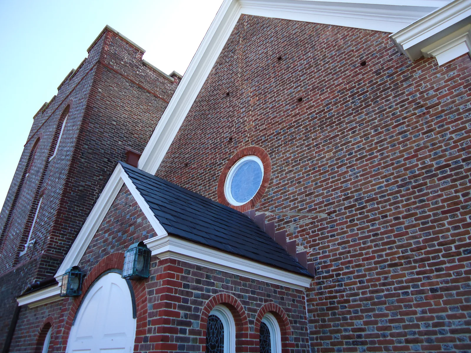 The church exterior, with its round gable window