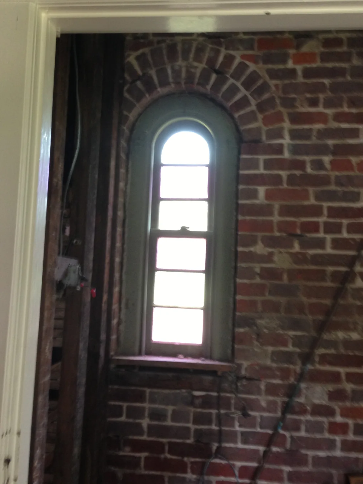 The sacristy window, set in the brick wall
