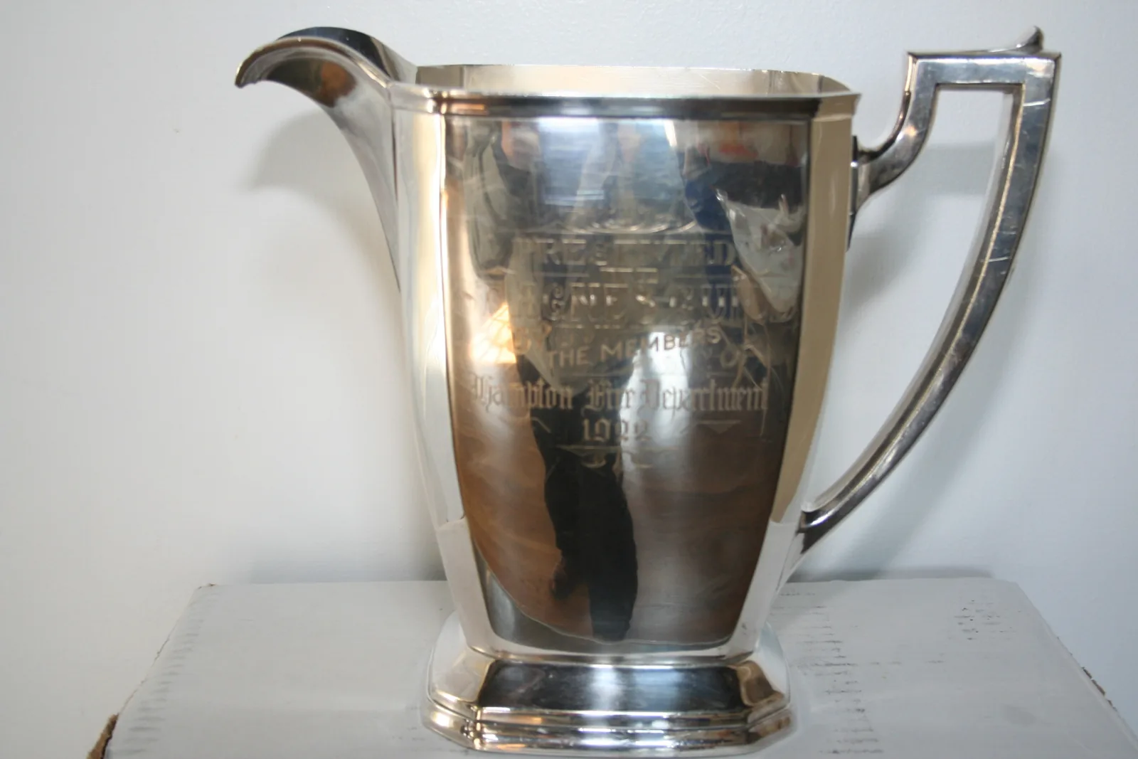 The engraved silver pitcher the Hampton Fire Department gave St. Agnes Guild in 1922
