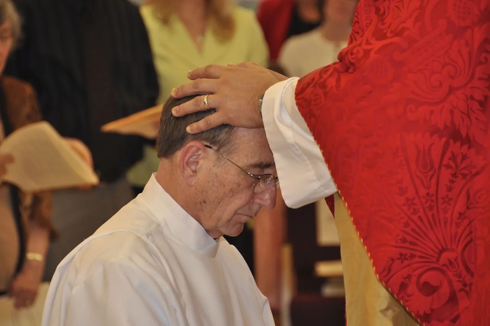 The laying on of hands at Bob Gay's ordination